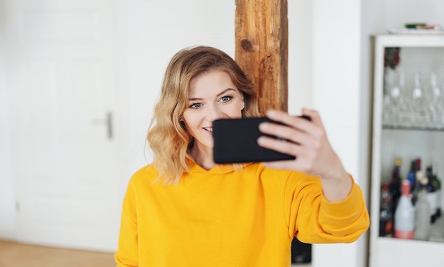 young Caucasian woman with a phone