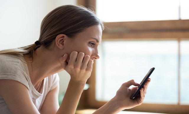 young Caucasian woman with a phone